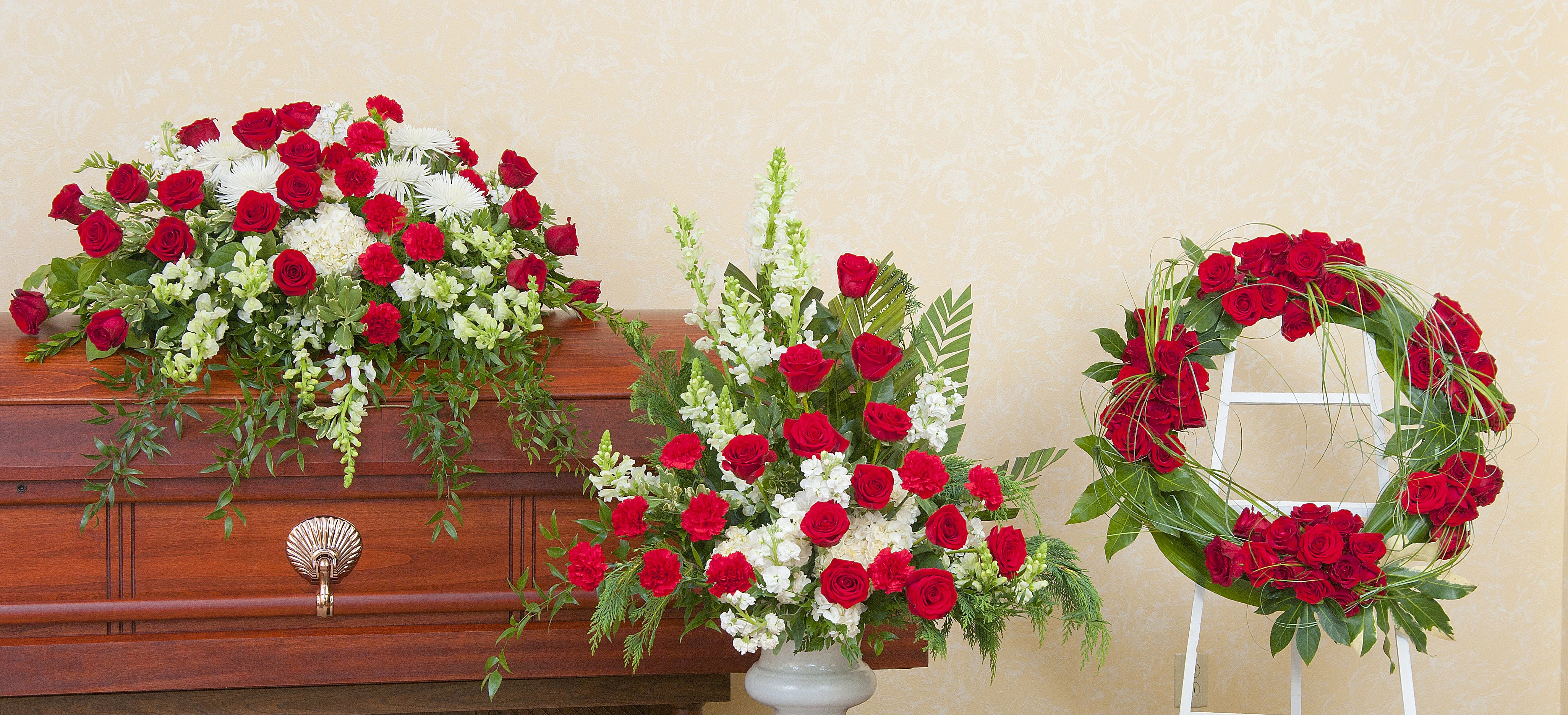 Casket spray, standing arrangement, and rose wreath in red and white