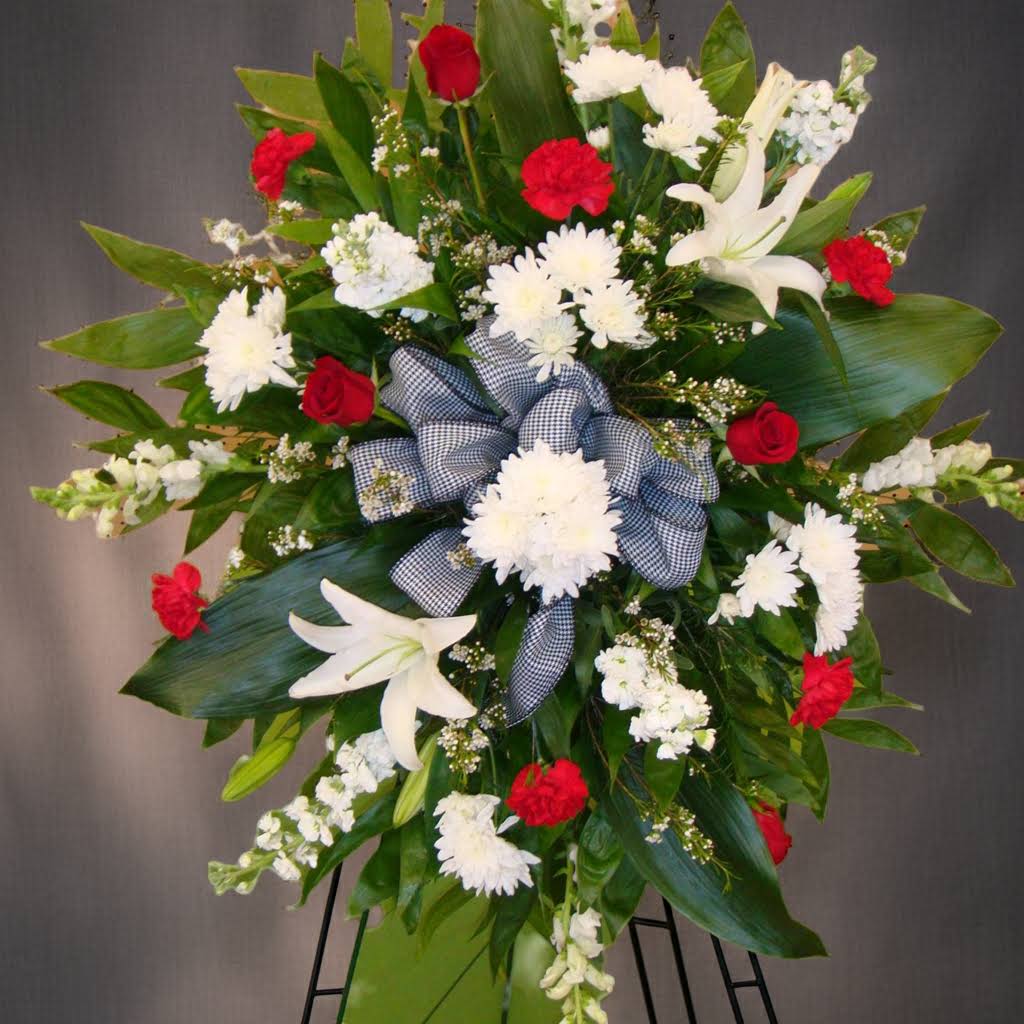 Standing floral spray with white lilies, red roses, and white chrysanthemums