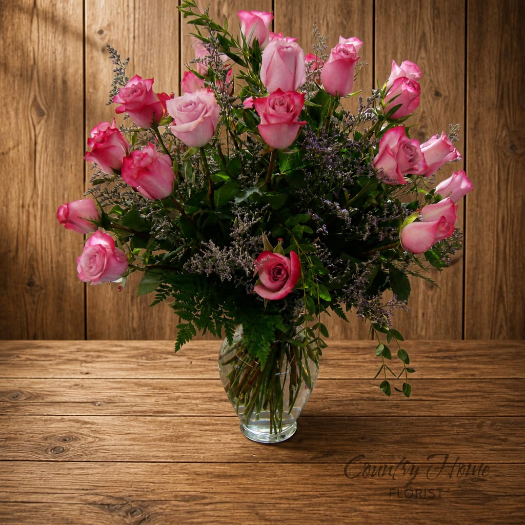 Pink roses arranged in a clear glass vase
