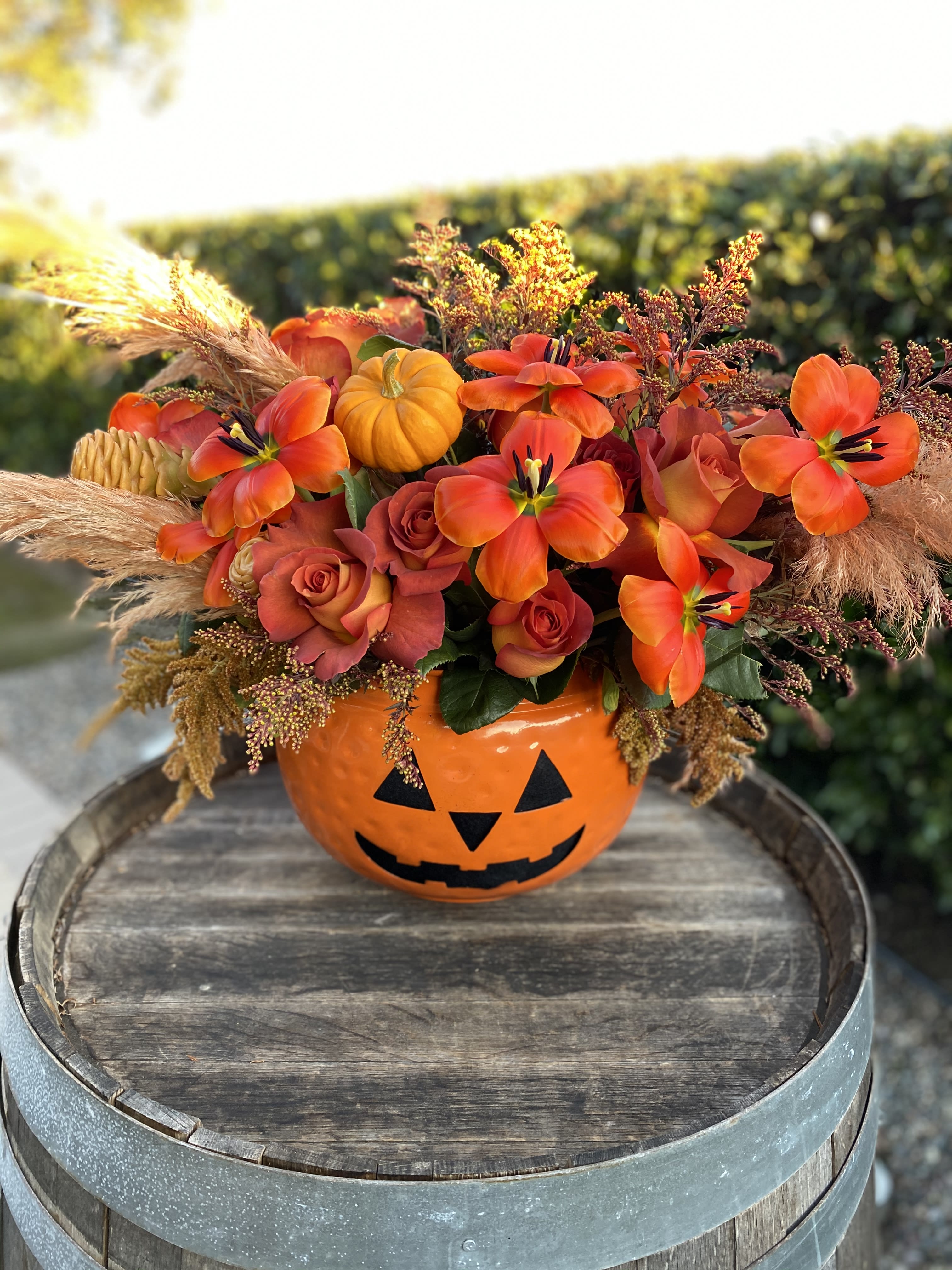 A Halloween Garden - This fun and spooky arrangement is perfect for this fall season. Enjoy the perfect combination of blooms, small pumpkins and greens. 