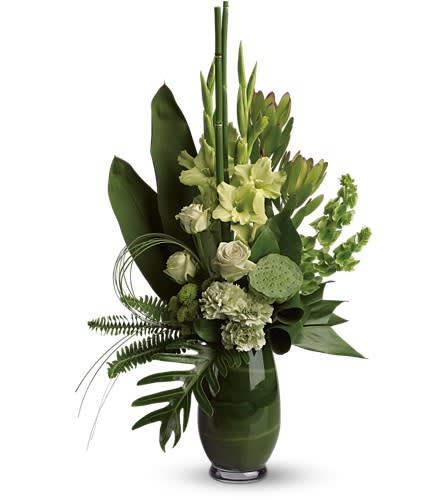 Green floral arrangement in a tall vase with lotus pods and tropical leaves