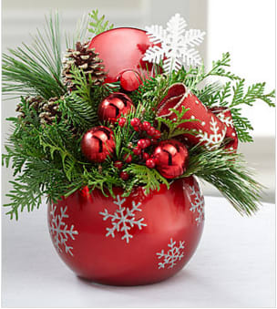 Fresh &amp; Festive Holiday Arrangement - The Fresh &amp; Festive Holiday Arrangement is an expression of holiday elegance set to send your warmest wishes to friends, family, or co-workers in honor of the Christmas season! A mix of lush, lovely, and perfectly fragrant holiday greens are accented with shining red ornament balls, faux berries, and a snowflake pic to create an exquisite arrangement they won't soon forget. Arriving in a red ornament inspired ceramic container featuring a glittering snowflake pattern, this arrangement is the perfect way to extend the joy and excitement of the yuletide season to your special recipient. Lid included with container so that it might become a treasured holiday keepsake for years to come. Your purchase includes a complimentary personalized gift message.