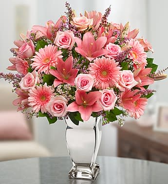 Dazzle Her Day - Product ID: 100231  EXCLUSIVE One look at this truly original arrangement of pink roses, lilies, Gerbera daisies and more will leave her smiling brighter than the vase it arrives in! We think itâs a brilliant gift idea for birthdays, anniversaries or any day you want to put that special someone in the spotlight. Luxurious arrangement of gorgeous pink roses, lilies, Gerbera daisies, waxflower and heather, accented with salal Artistically designed by our expert florists inside a shimmering keepsake silver vase; measures 10"H Large arrangement measures approximately 18.5"H x 12"L Medium arrangement measures approximately 18"H x 11.5"L Small arrangement measures approximately 17.5"H x 11"L Our florists select the freshest flowers available so colors and varieties may vary Lilies may arrive in bud form and will open to full beauty over the next 2-3 days
