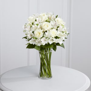 White rose bouquet in a clear glass vase