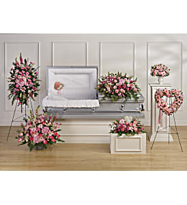 Pink floral funeral display around a white casket