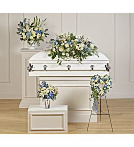 White casket with blue and white floral sprays