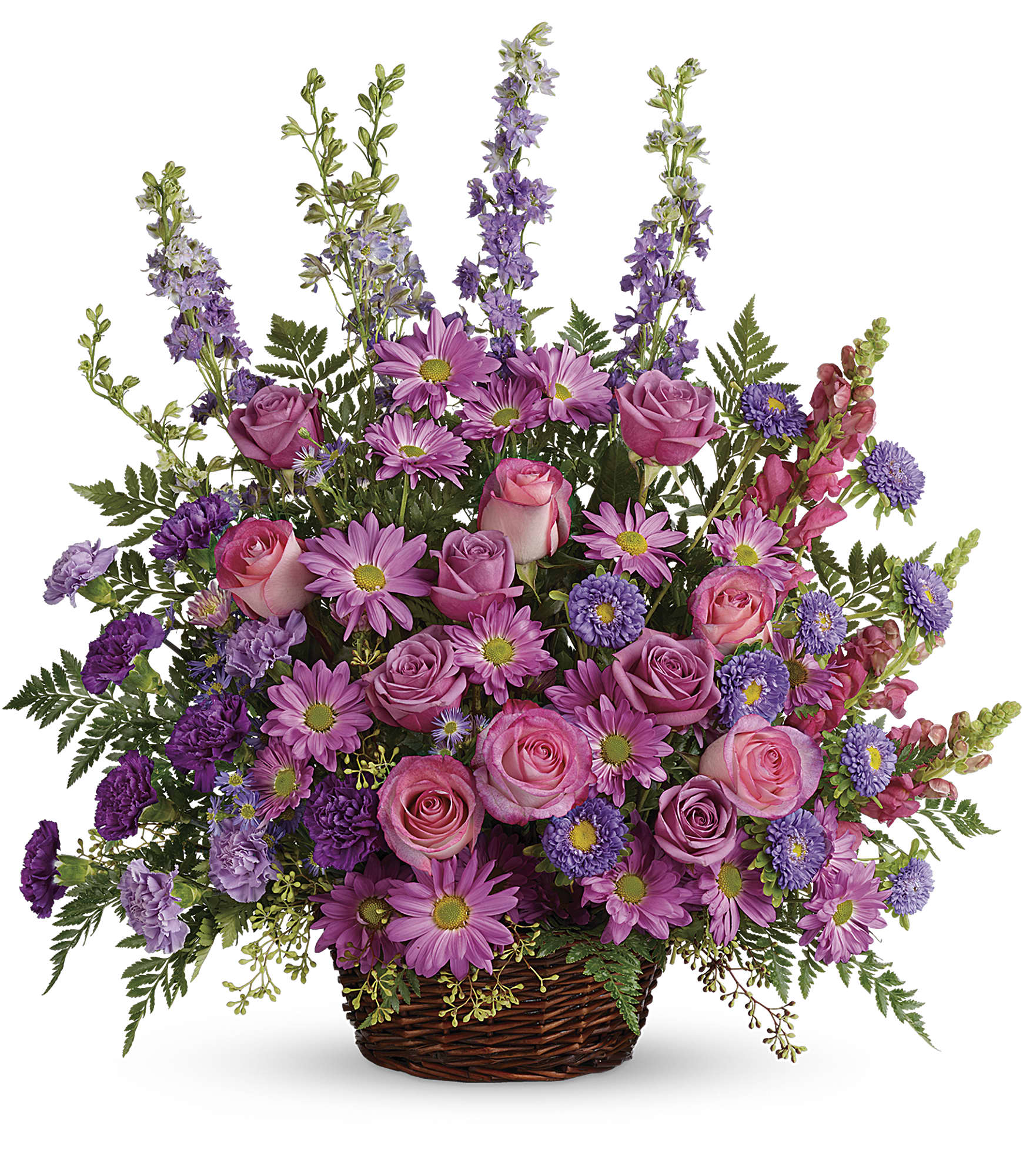 Pink and purple mixed flower arrangement in a wicker basket