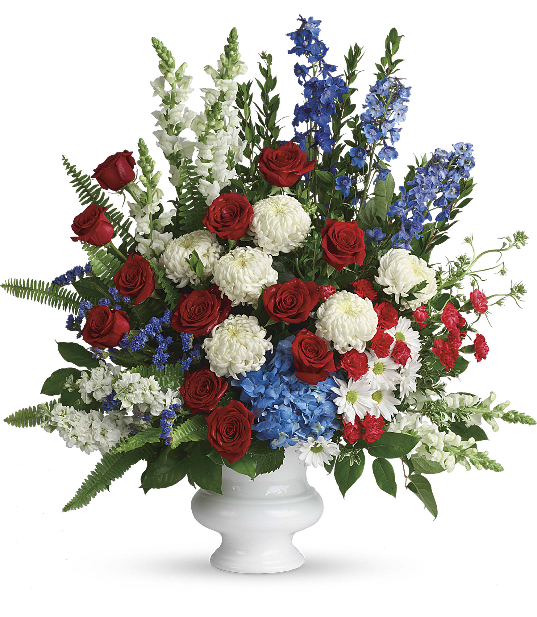 Red roses, white mums, and blue delphinium in a white vase