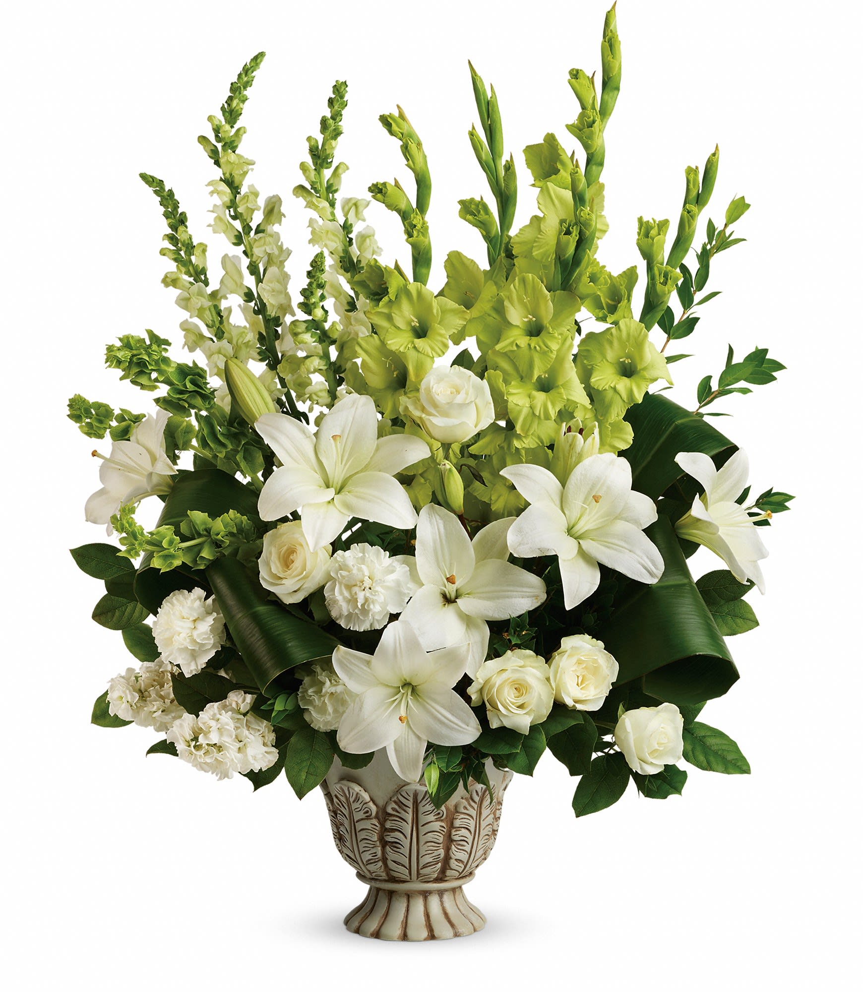 White lilies and roses arranged in a decorative vase with green flowers