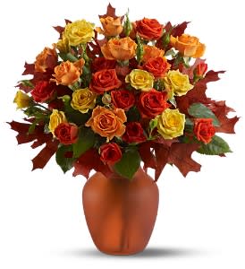Amber Roses - Natural amber comes in every shade of gold - and this striking display of fresh spray roses in autumn's favorite hues of gold and orange, accented with a few oak leaves, is perfectly precious! A lovely pick-me-up for a crisp fall day.