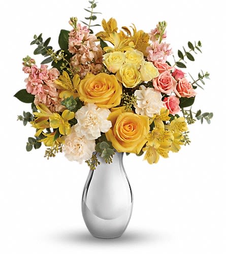 Yellow and pink mixed flower bouquet in a clear glass vase