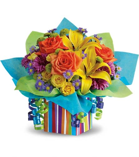 Bouquet of orange roses and yellow lilies in a striped gift box