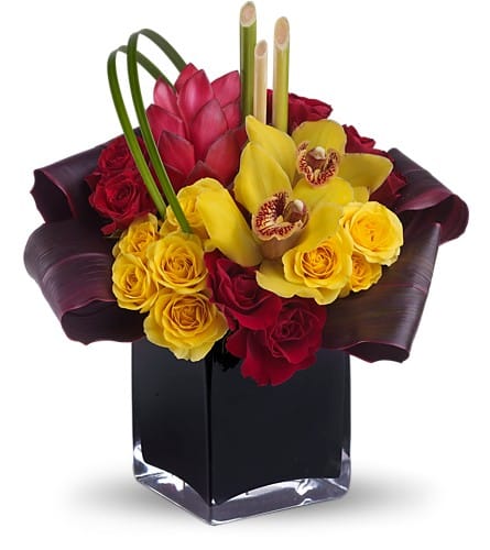 Bouquet of red and yellow roses with orchids in a black vase