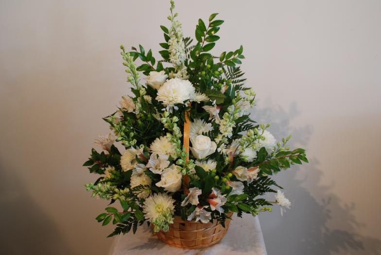 White floral arrangement in a woven basket