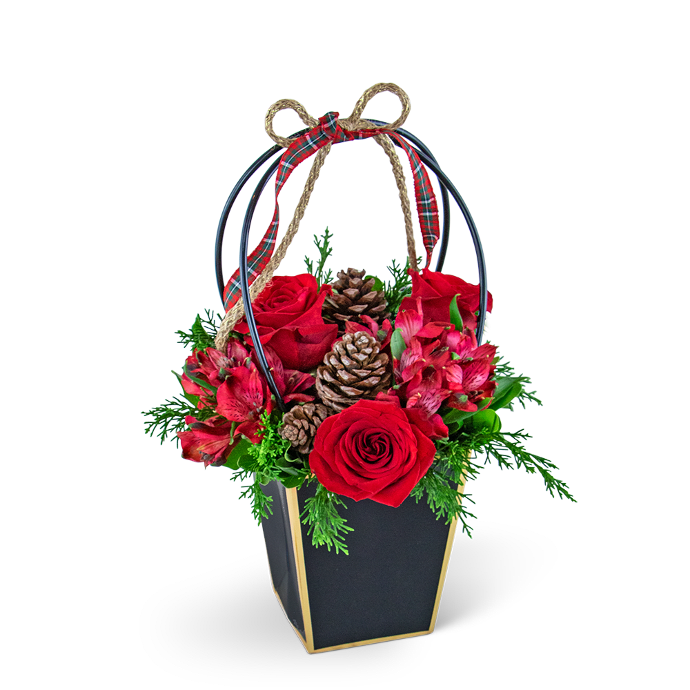 Piney Rose Holiday Tote - Embrace the holiday spirit with our Piney Rose Holiday Tote. This charming design features a delightful combination of roses, alstroemeria, and evergreen, expertly arranged in a convenient and easy-to-carry flower gift bag. These flowers create a festive blend that is sure to bring a touch of seasonal beauty and cheer to any celebration or gift-giving occasion.