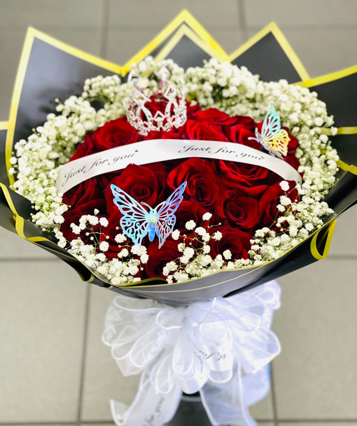 Red rose bouquet with white baby's breath and decorative butterflies