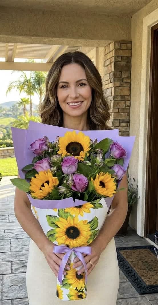 Bouquet of yellow sunflowers and lavender roses wrapped in purple paper