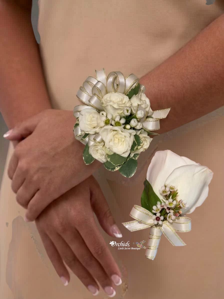 Two white floral wrist corsages worn on arms, each tied with ribbon.