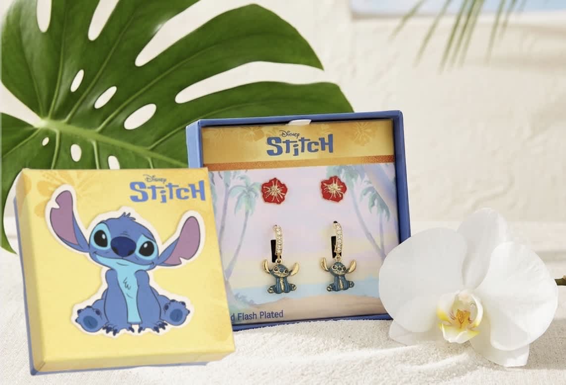 White orchid beside Stitch-themed jewelry boxes