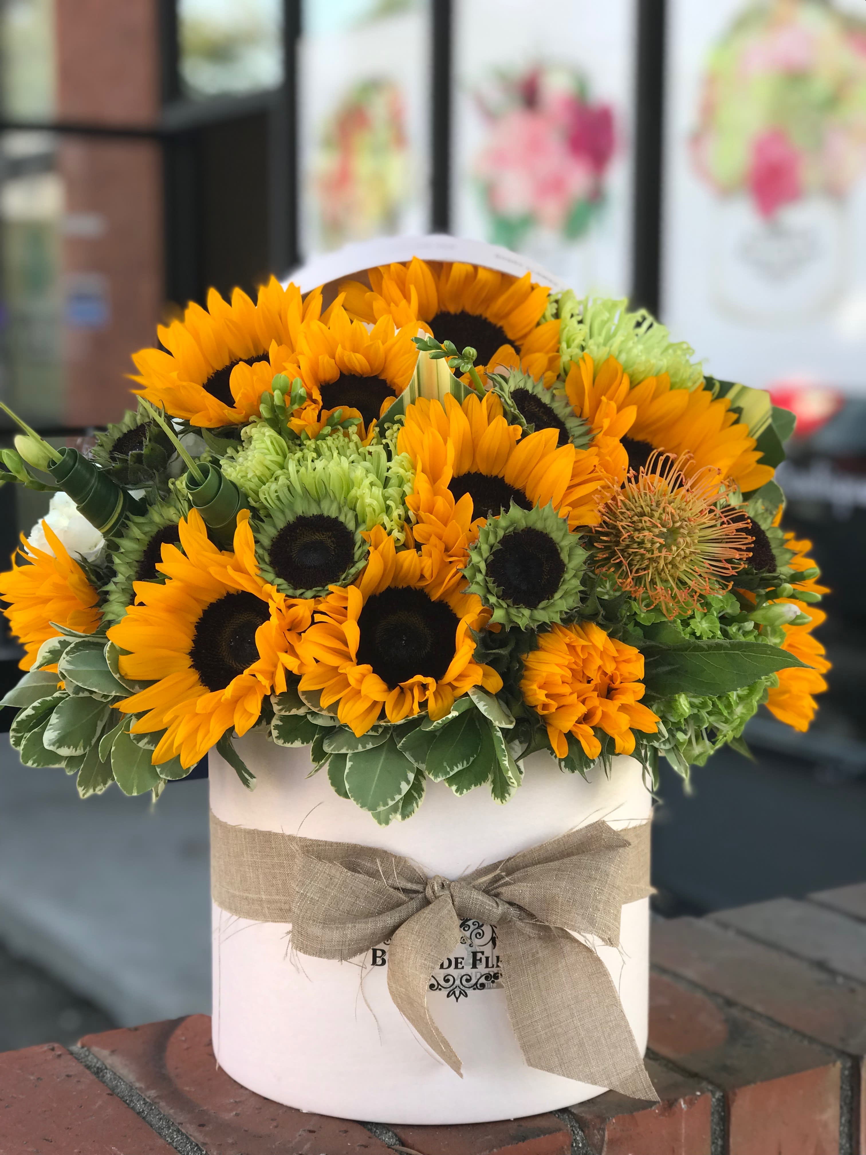 Sunflower bouquet in a white hatbox with a burlap bow