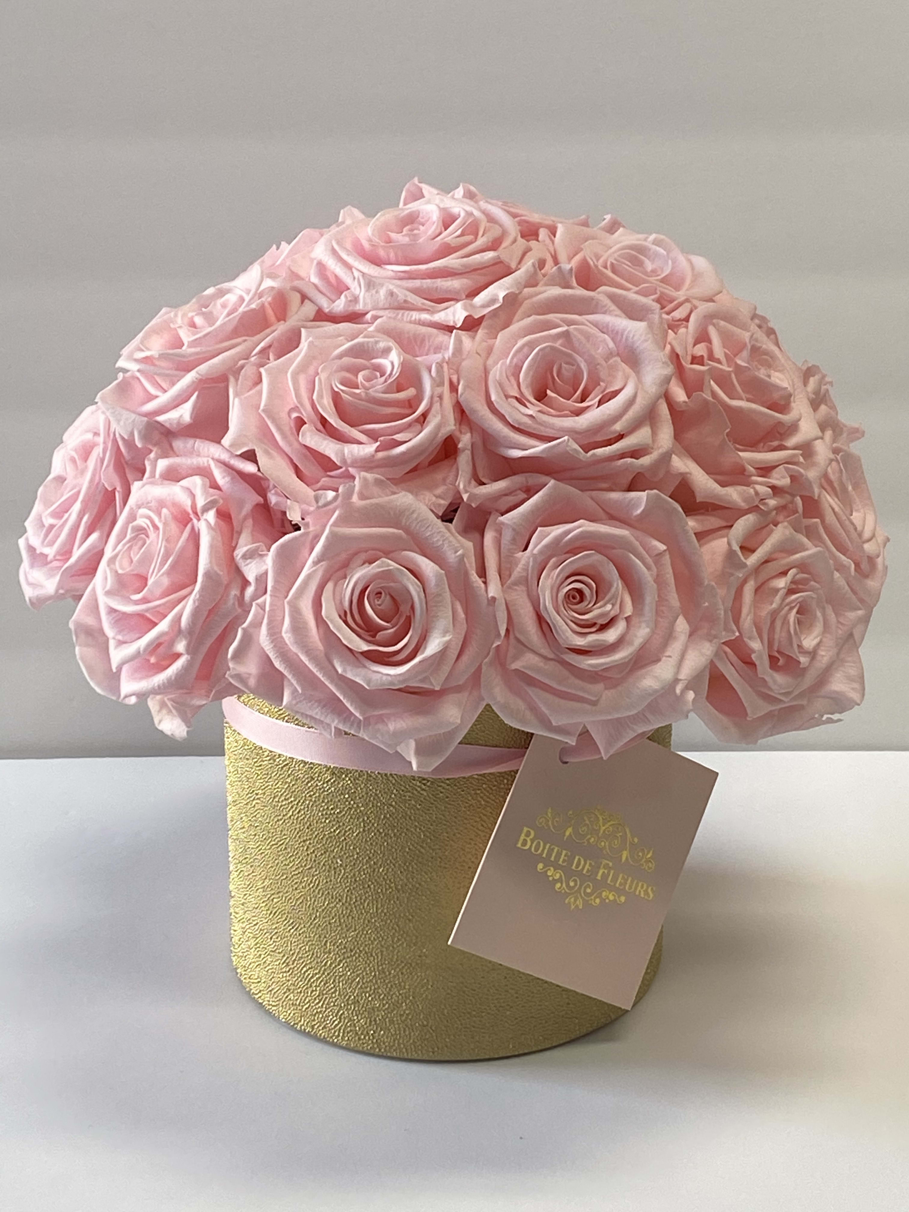 Pink rose bouquet in a gold round box with a hanging tag