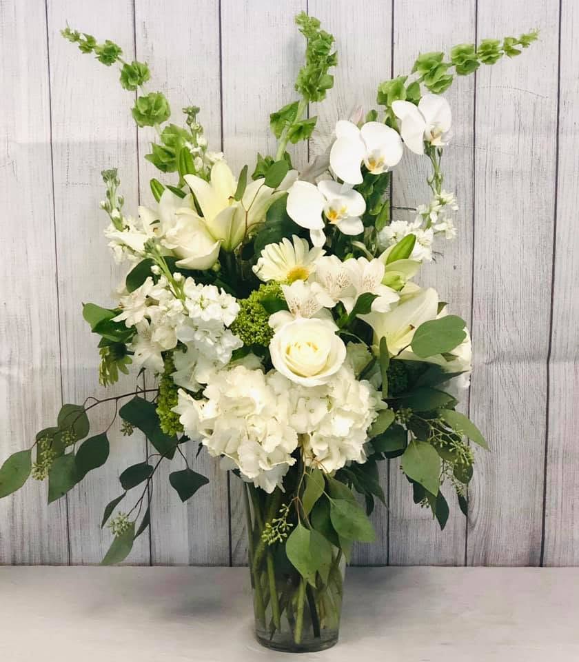 CFS149 - A tall &amp; showy vased arrangement of high end white and green flowers such as hydrangeas, roses, lilies and other blooms. 