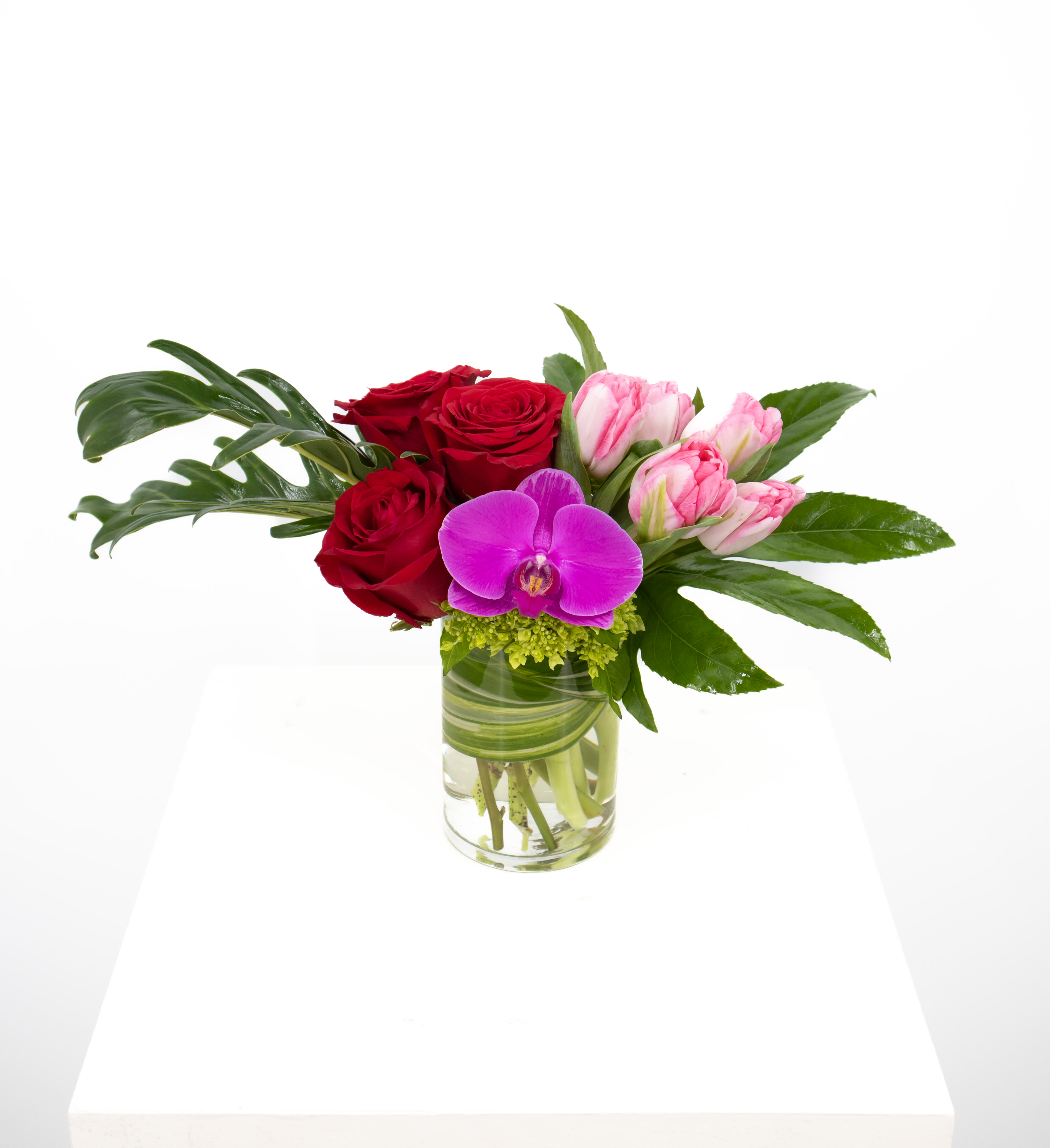 Chelsea  - This stunning arrangement that includes gorgeous roses of your color preference along with vibrant tulips, lush hydrangea and topped off with breath taking orchid blossoms is perfect for the anyones special valentine.