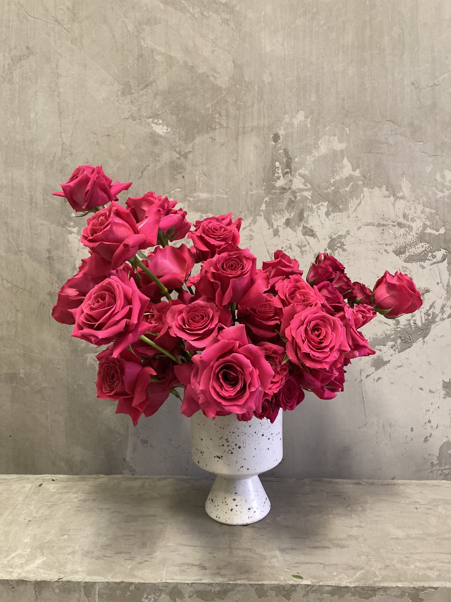 Rosée Romantique - Rosée Romantique" is a delicate and captivating arrangement of hot pink roses, symbolizing love, passion, and excitement. The vibrant and bold hues of the blooms exude a sense of confidence and playfulness, while the soft and fragrant petals evoke a sense of tenderness and sensuality. The arrangement is expertly crafted, each stem carefully placed to create a beautiful and romantic display. Whether gifted to a special someone or displayed in your own home, "Rosée Romantique" is sure to evoke feelings of love and adoration, making it a perfect expression of passion and romance.