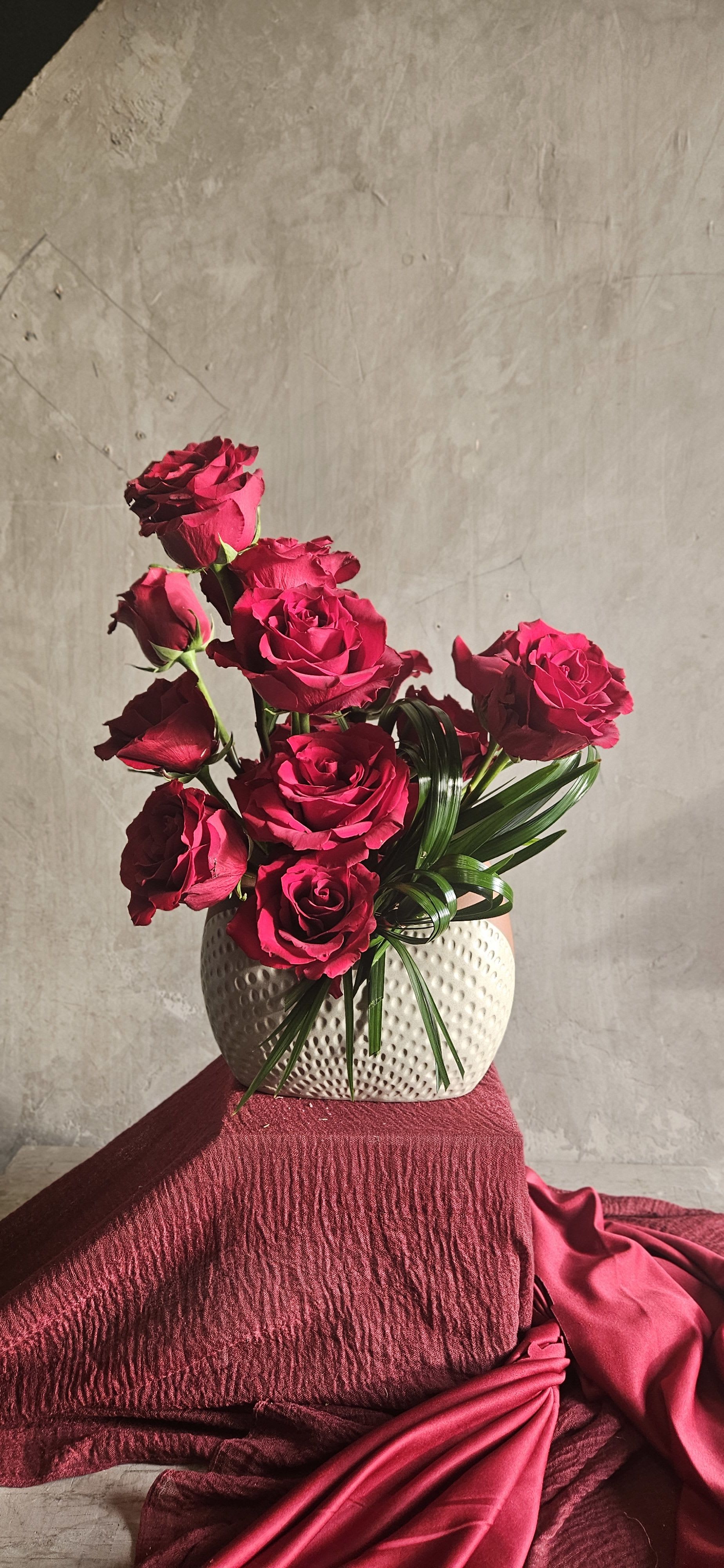 Velvet Rouge - A refined composition of premium long-stem deep red roses arranged in a modern ceramic vase with sculpted greenery accents.  Designed for those who appreciate bold elegance and timeless romance, Velvet Rouge makes a powerful statement while maintaining a clean, sophisticated aesthetic.