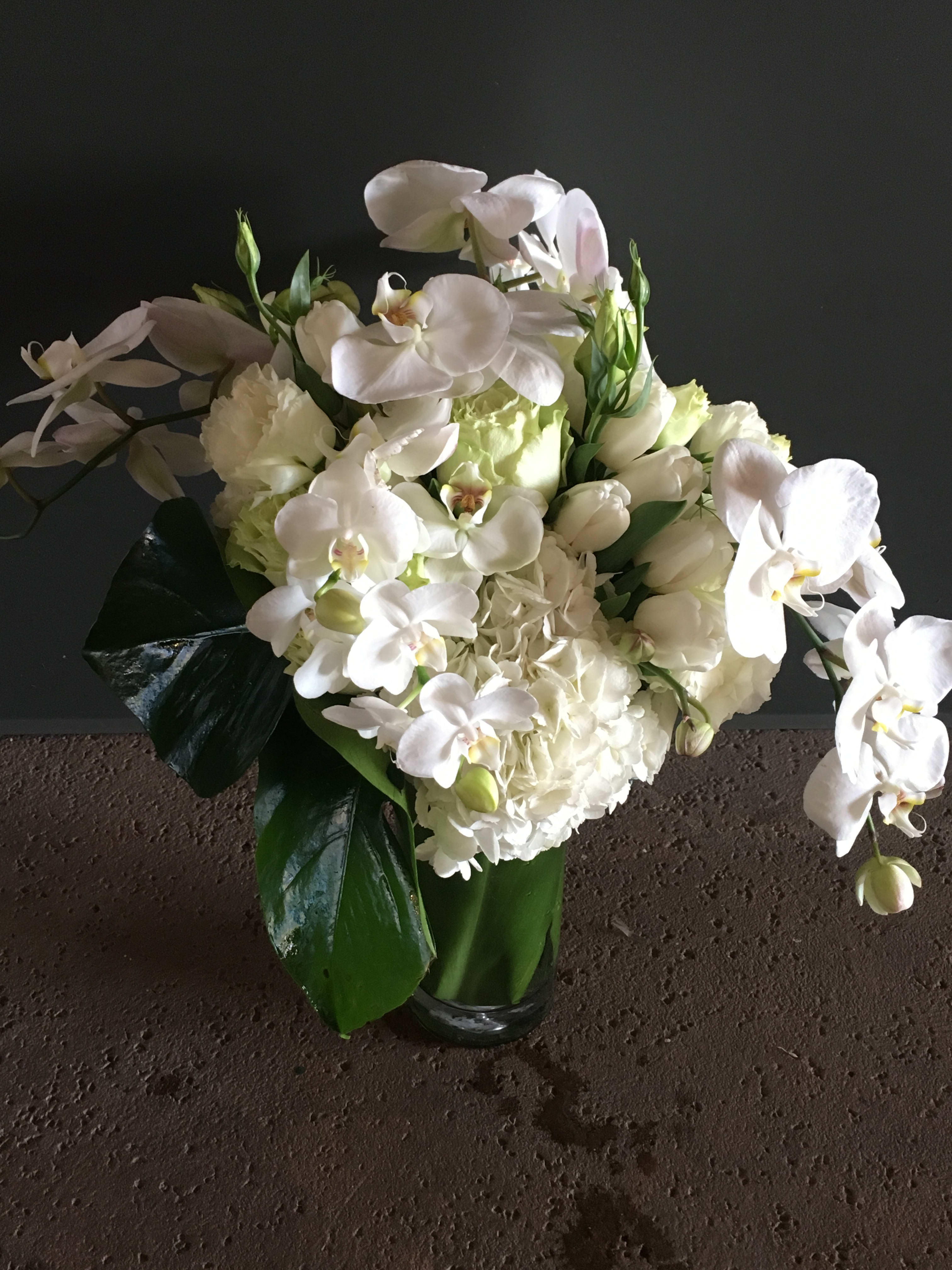 White orchid and hydrangea bouquet in a glass vase