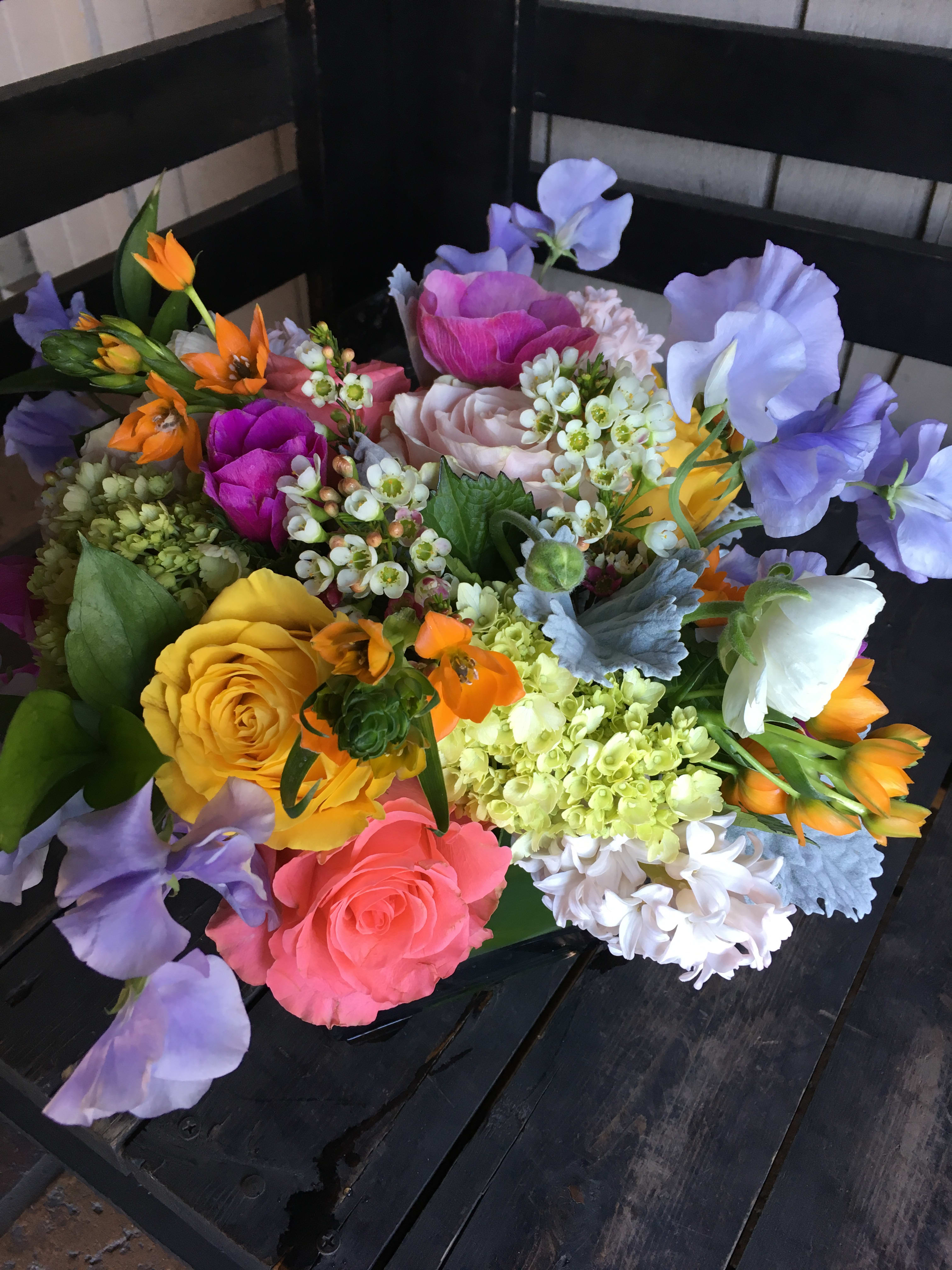 Colorful bouquet of roses, sweet peas, and mixed blooms