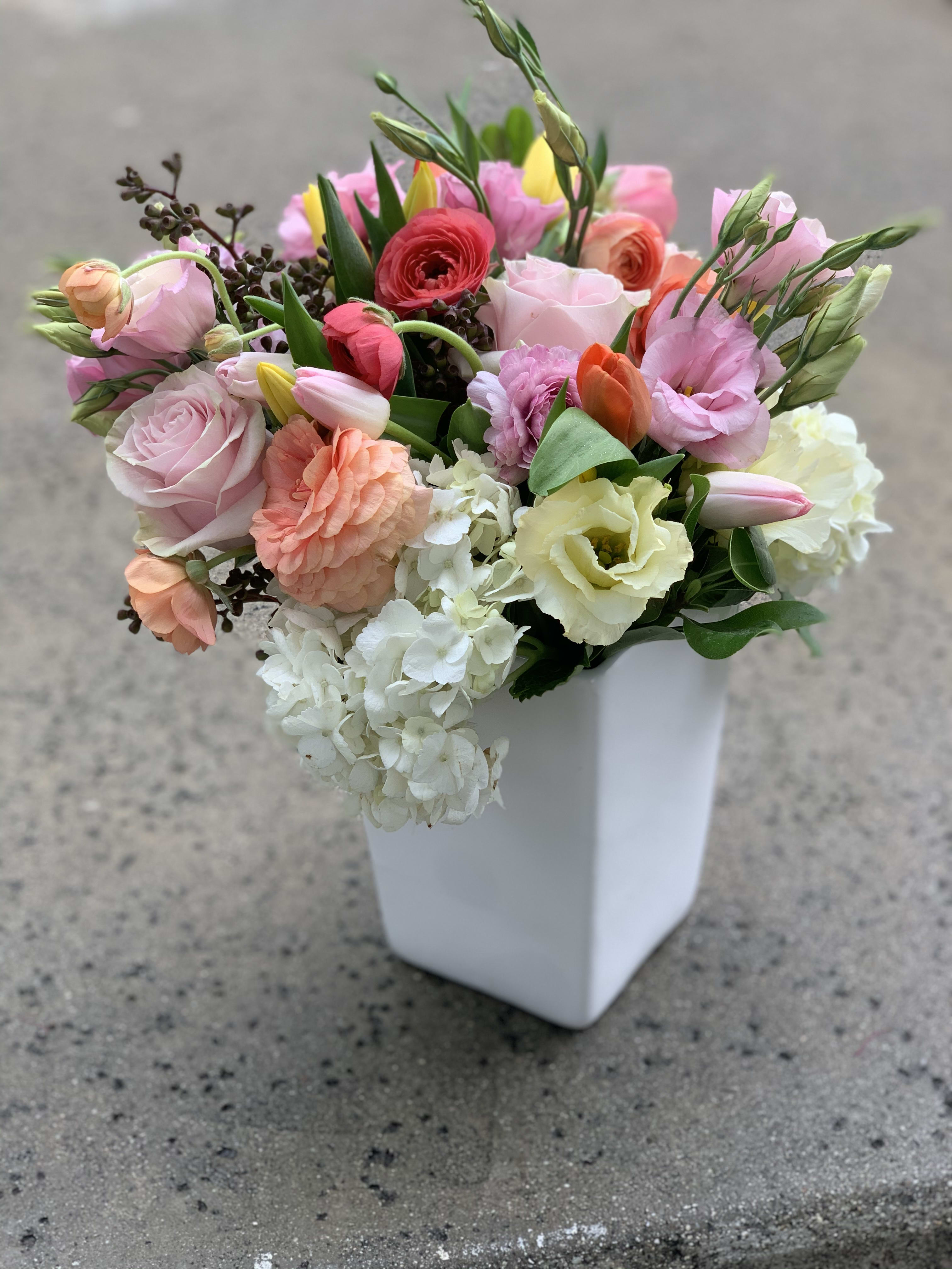 Mixed pastel bouquet in a white square vase