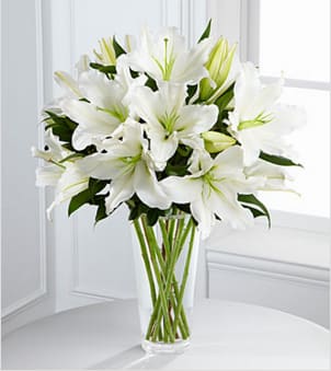 The FTD® Light in Your Honor™ Bouquet - The FTD® Light in Your Honor™ Bouquet is a beautifully bright arrangement bursting with elegant fragrance to convey your deepest sympathies for the loss of their loved one. A stunning bouquet of gorgeous Oriental lilies are accented with lush greens and seated in a clear glass vase to create a bouquet that is serenely sophisticated, offering comfort and peace in their time of need. GOOD bouquet includes 8 stems. Approximately 22"H x 15"W. Your purchase includes a complimentary personalized gift message.