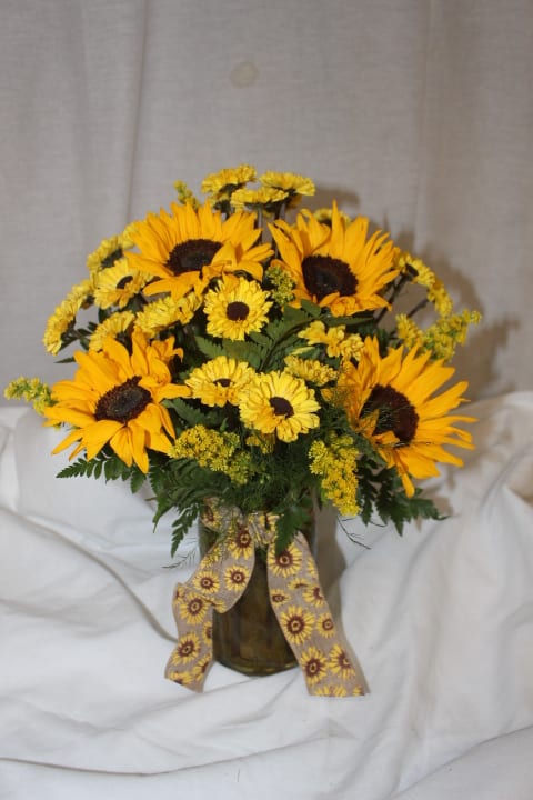 It's All Sunshine - With fun, bright flowers meant to bring extra sunshine into anyone's day, this bouquet captures the bright feelings of happiness. It will not blend into the background, but will stand out as a aura of sunshine.