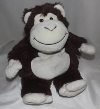 Plush monkey toy with a smiling face and white hands and feet