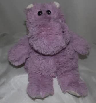 Purple plush teddy bear with black eyes and white paws