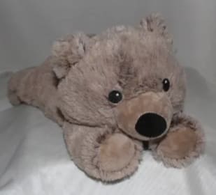 Plush teddy bear lying on a bed