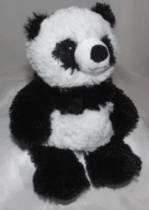 Plush panda bear sitting upright on a light background