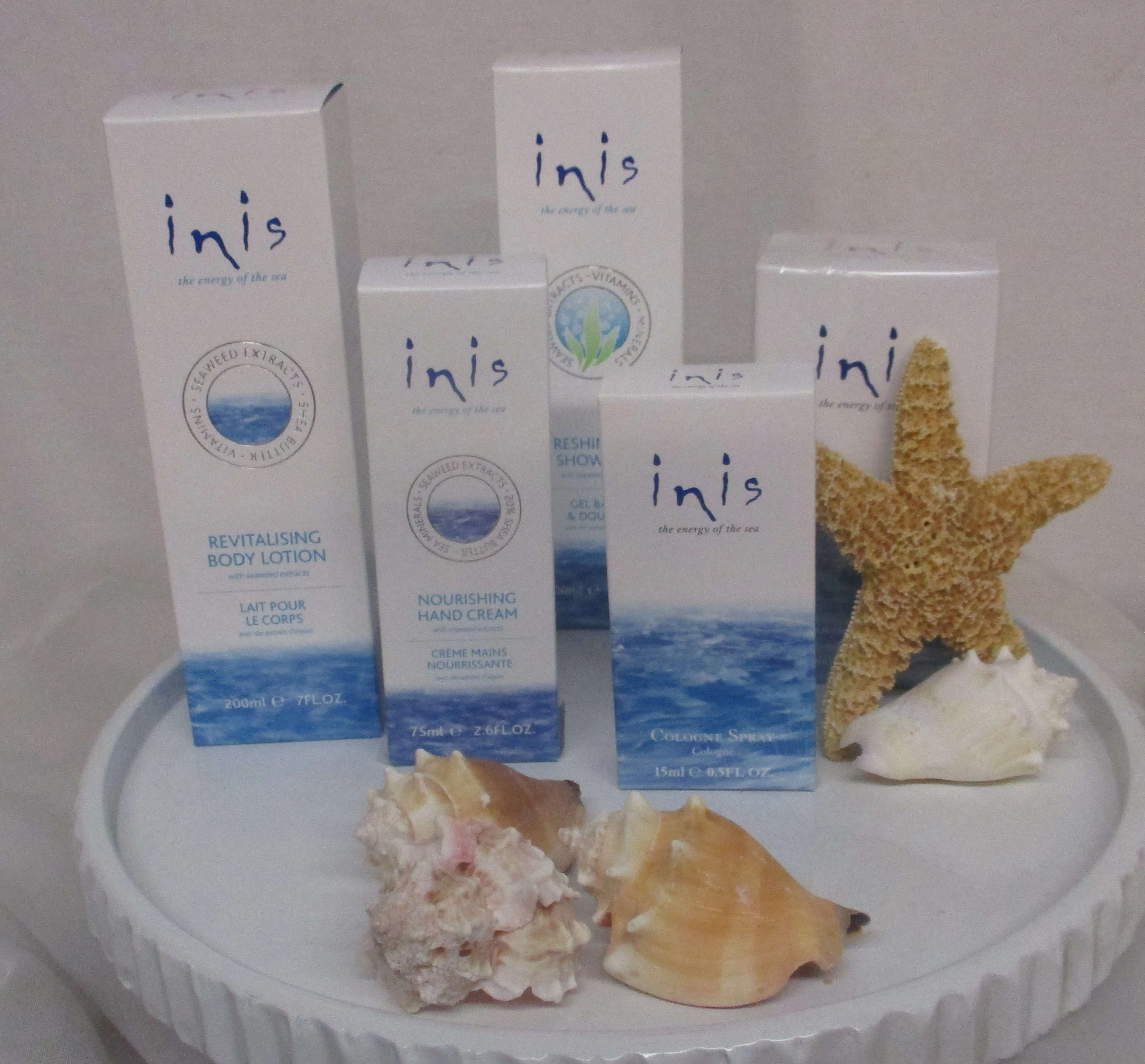 Innis skincare boxes arranged with seashells and a starfish on a round display