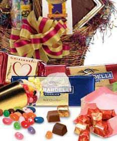 Gift basket with assorted chocolates, candy, and a striped bow