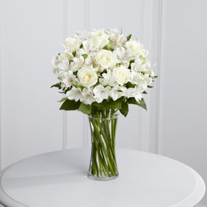 White rose and alstroemeria bouquet in a clear glass vase