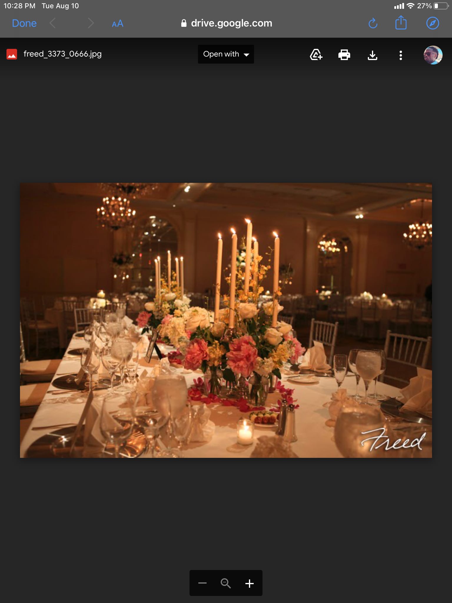 Tall floral centerpieces with candles on a decorated banquet table