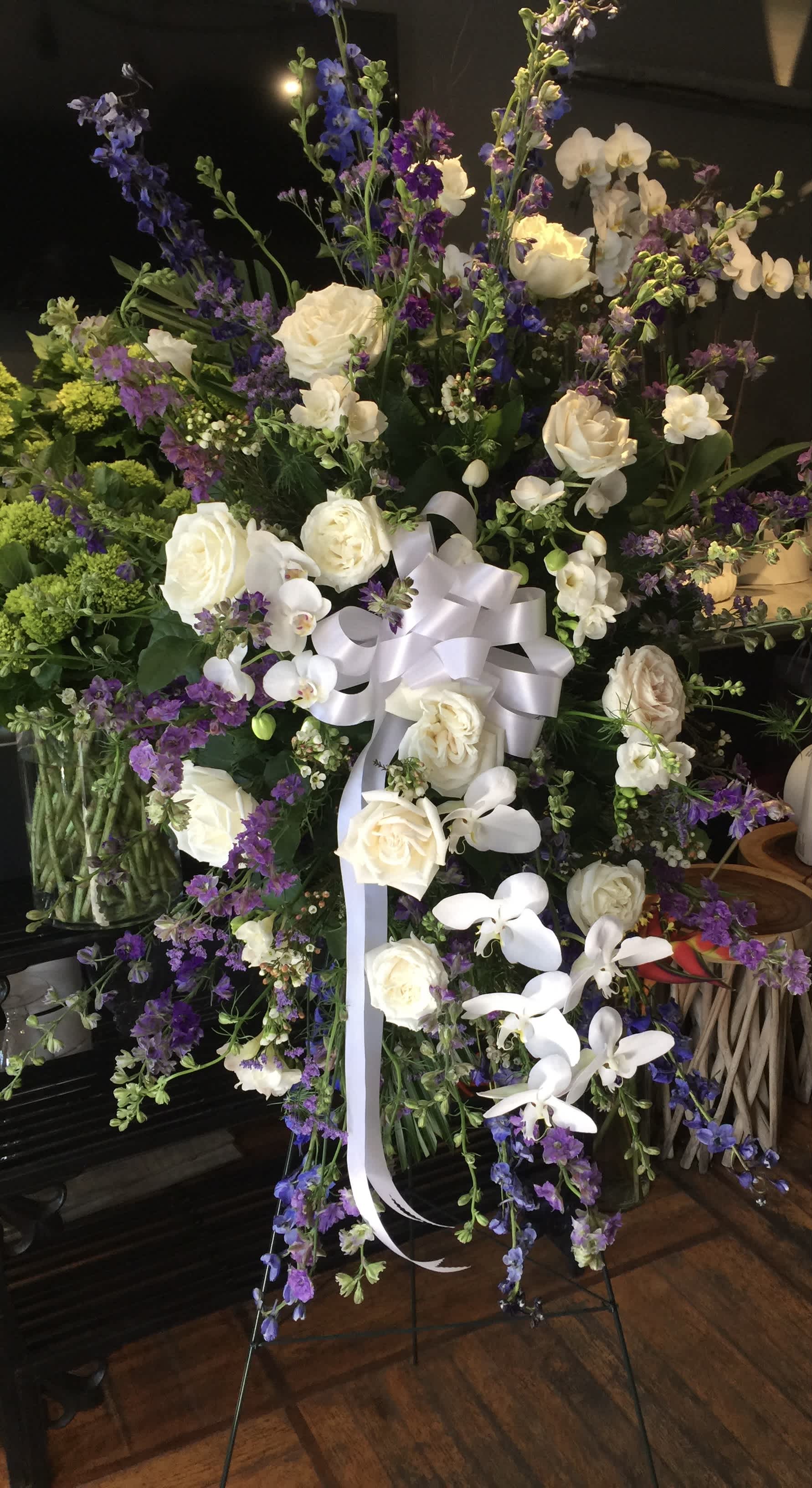 Large standing floral spray with white roses and purple flowers