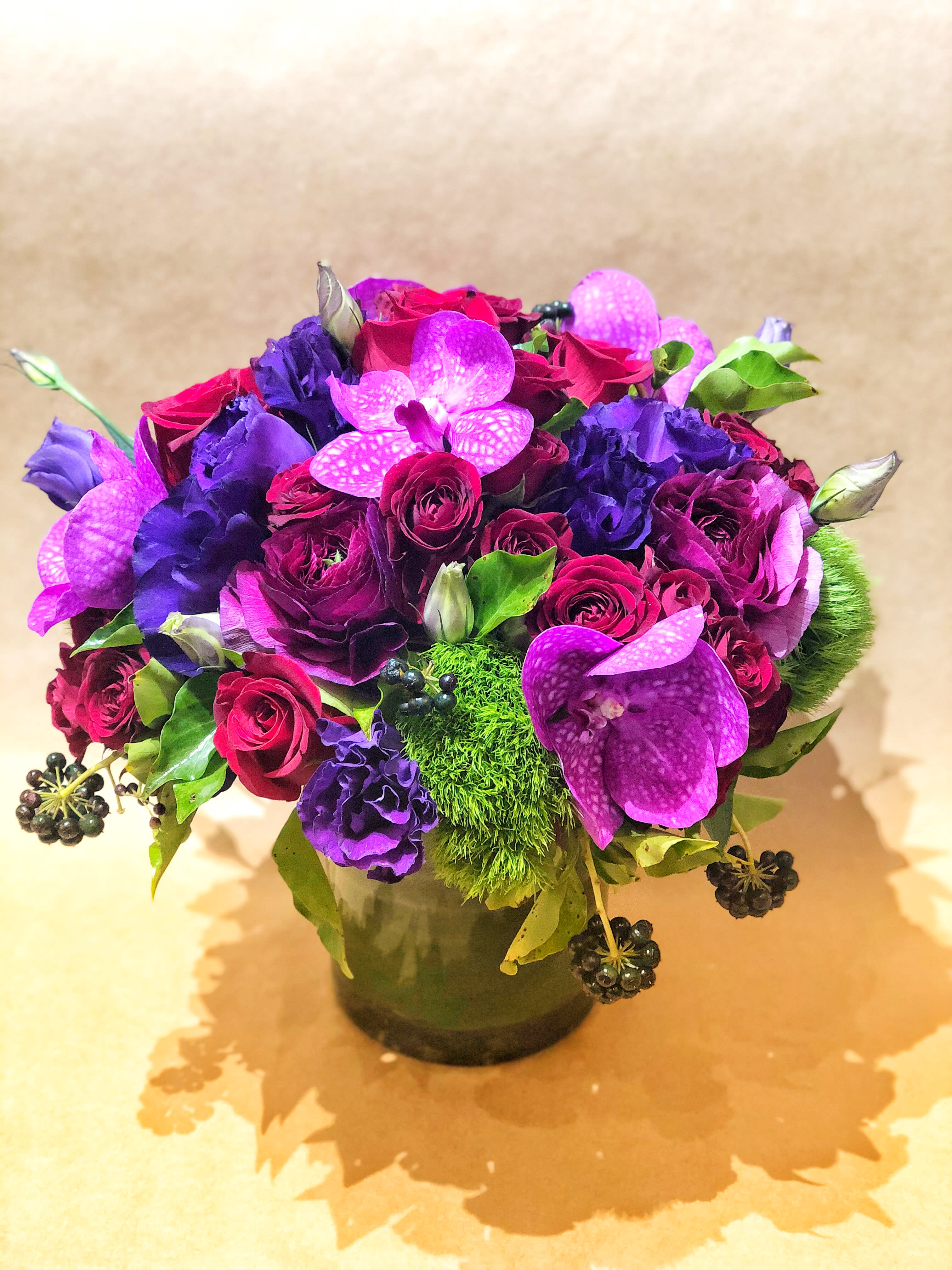 Purple and pink flower arrangement in a glass vase