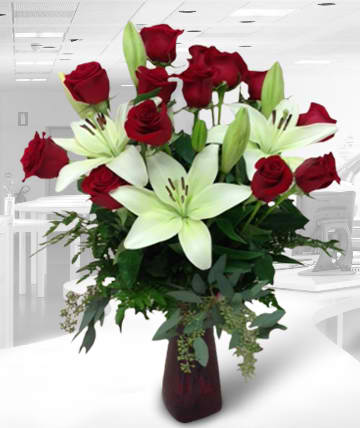 Red roses and white lilies in a tall vase