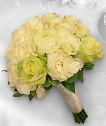 Bouquet of pale yellow roses wrapped in beige paper