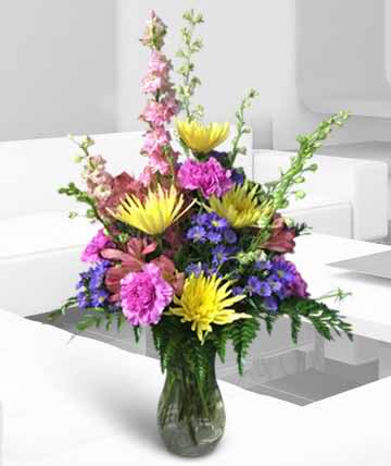 Colorful mixed flower arrangement in a glass vase
