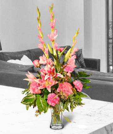 Pink floral arrangement in a clear glass vase