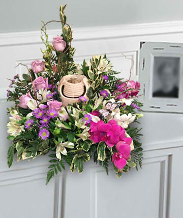Pink and white floral arrangement with a small basket centerpiece