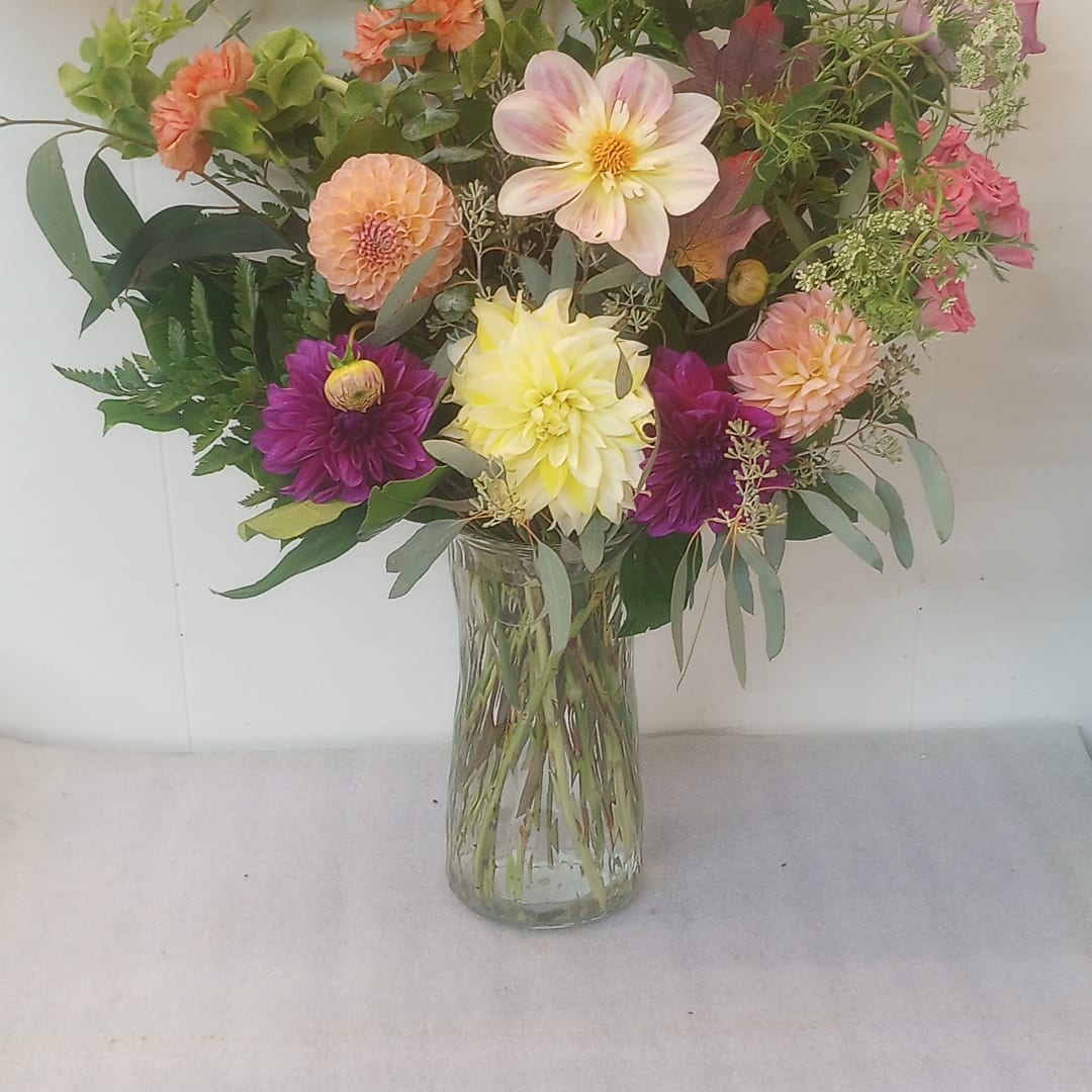 Mixed bouquet of dahlias in a clear glass vase